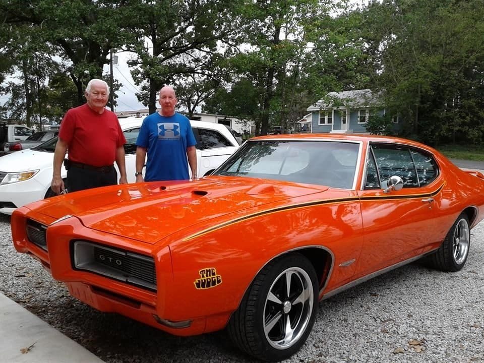 An orange 1969 Pontiac GTO Judge parked outside Kilby Automotive